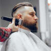 Man with a beard. Hairdresser with a client. Man in a red shirt